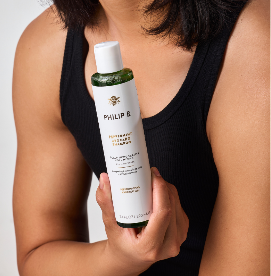 person-holding-philip-b-peppermint-avocado-shampoo